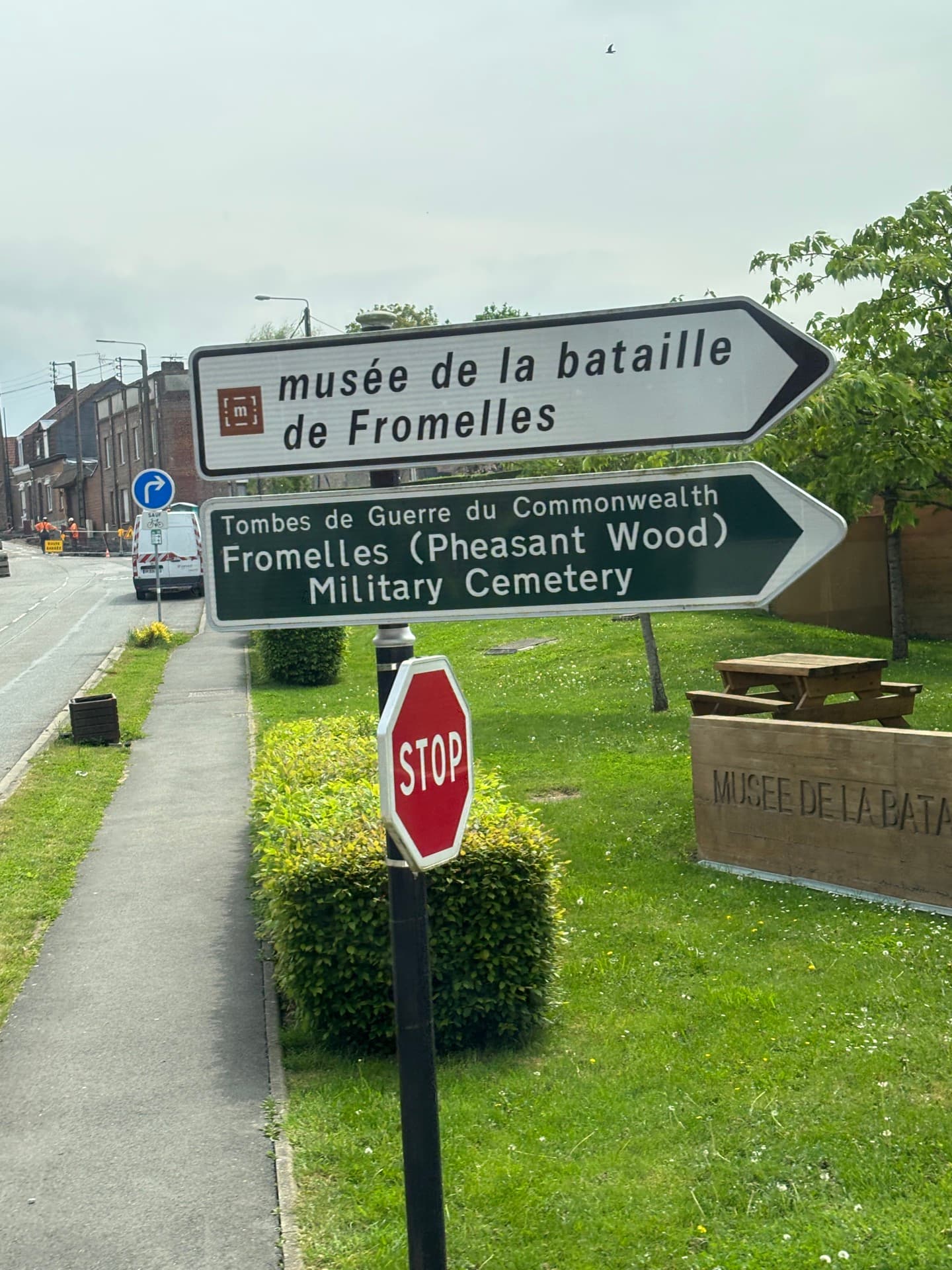 A French STOP sign and roadside directional signs