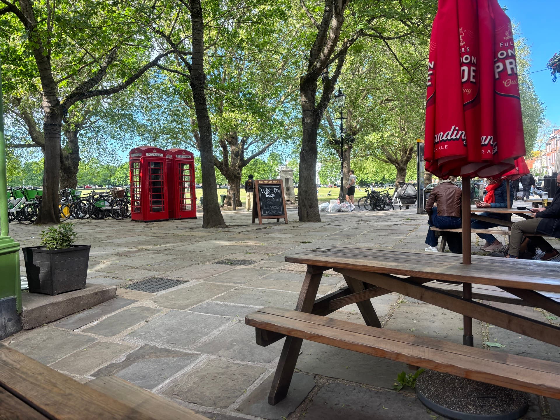 A pub garden with classic red telephone boxes, London